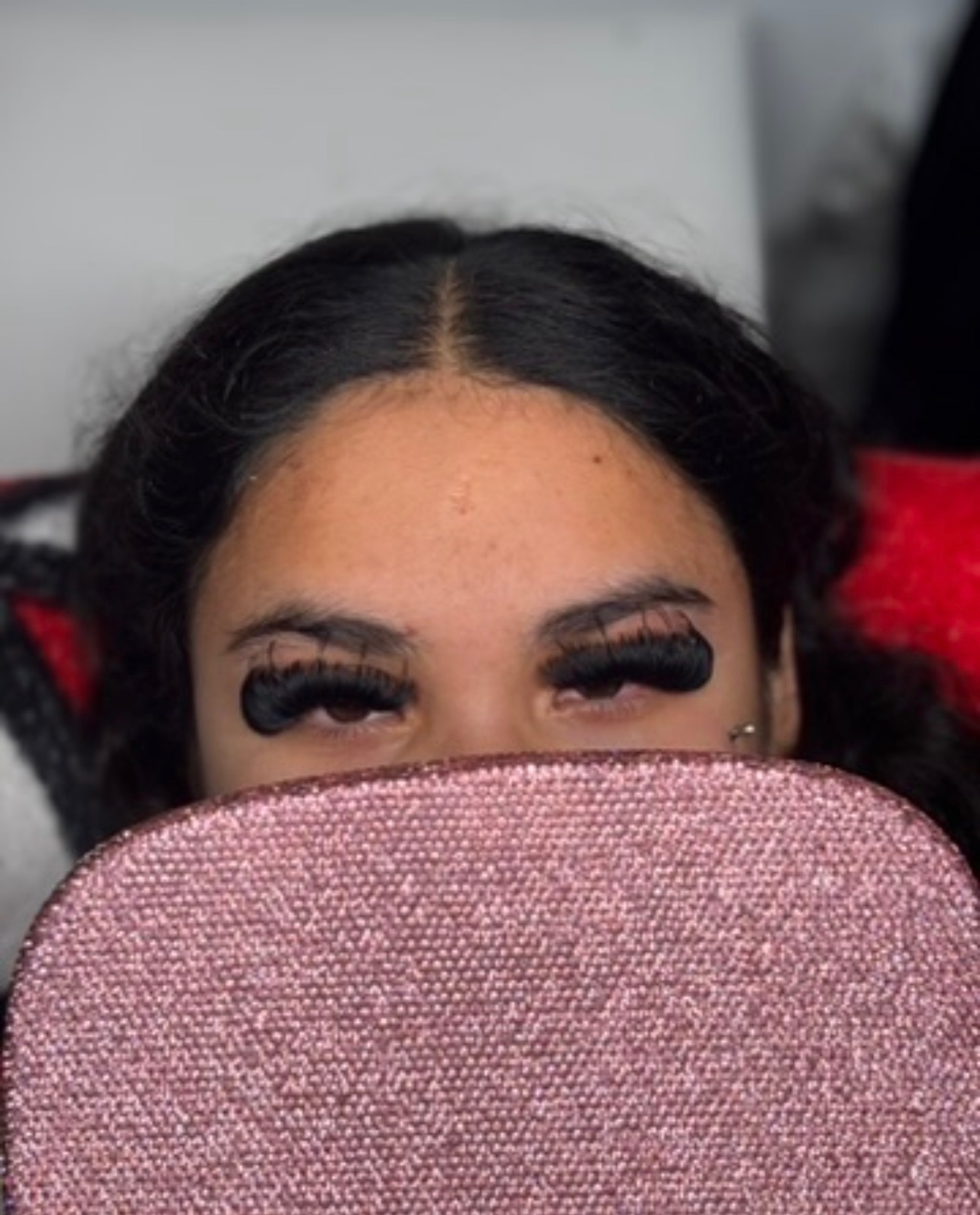 Mega volume lashes styled with pink glitter prop by Exotic Blinkzz